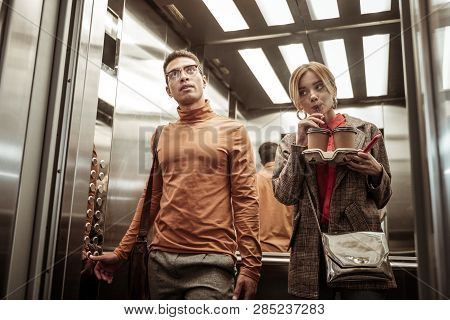 Couple Of Businessmen Taking The Elevator While Going To Work