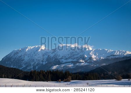 Snow Covered Mountain Range With Mountains Grimming, Schartenspitze And Steinfeldspitze On A Sunny W