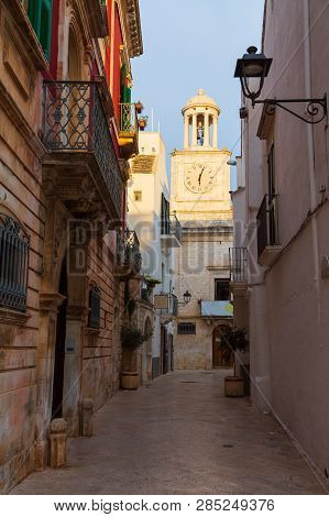 Street In Locorotondo And Town Hall Clock Tower, Province Bari, Sauthern Italy