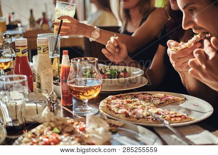 Pizza Time. Young Friends Students Eat Pizza And Salads In An Outdoor Caf During Lunch Break