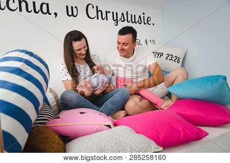 Smiling happy family and young funny daughter. Family concept.  On background Bible verses philippia