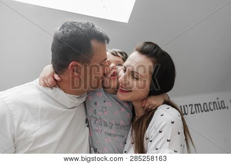 Smiling Happy Family And Young Funny Daughter. Family Concept.  On Background Bible Verses Philippia