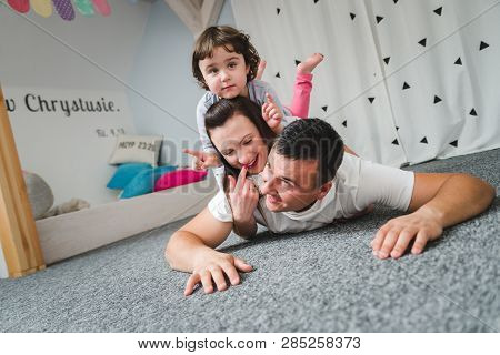 Smiling Happy Family And Young Funny Daughter. Family Concept.  On Background Bible Verses Philippia