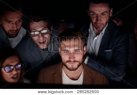 close up. the programmer and his colleagues are working late