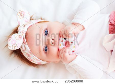 Cute Little Baby Girl Nibble A Silicone Doughnut Teether
