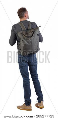 Back view of a man with a green bag.  backside view of person.  Rear view people collection. Isolated over white. Stylish guy in gray with a big green backpack on his back is looking sideways.