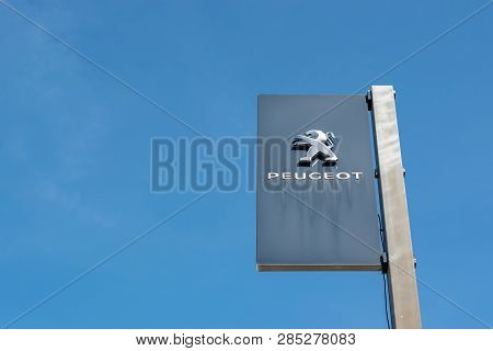 Roncq,france-february 20,2019:  View Of A Peugeot Brand Logo On A Blue Sky Background.peugeot Is A F