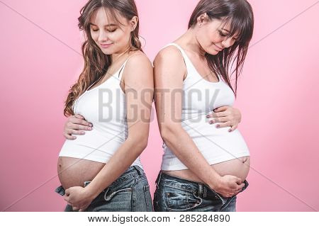 Maternity Concept, Two Pregnant Women With An Open Tummy