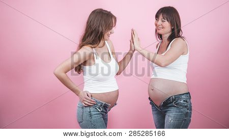 Maternity Concept, Two Pregnant Women With An Open Tummy
