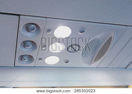 overhead light and air conditioner in airplane cabin