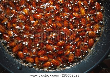 roasted almonds with cinnamon sugar cooking process, top view close-up