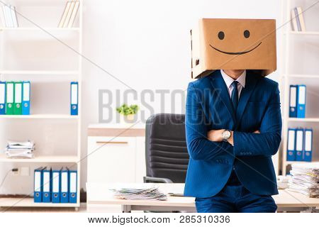 Happy man employee with box instead of his head