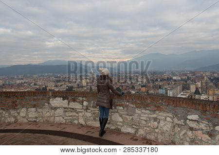 Woman Is Watching  Brescia Cityscape From The Castle's Tower. Lombardy, Italy.