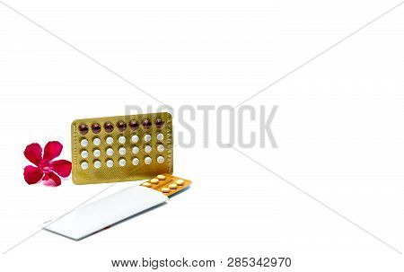 Contraceptive Pills Or Birth Control Pills With Pink Flower On White Background With Copy Space. Hor