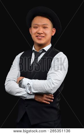 Asian Young Man In A Hat Smiles And Looks At The Camera