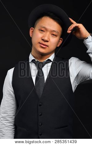 Photo Of An Asian Man With A Tie And A Shirt, He Raises His Hat By Congratulating