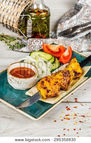 Skewers, Onions, Pita Bread, Sauce On A White Plate