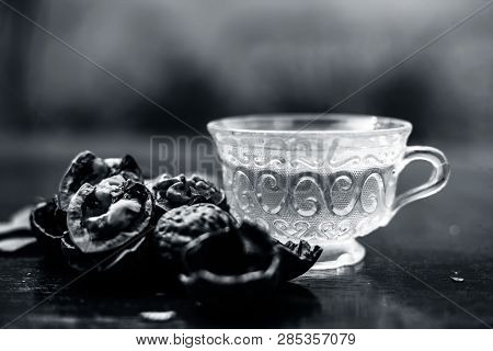 Close Up Of Herbal Organic Tea Of Wall Nut Or Walnut Tea In A Transparent Glass Cup With Raw Wall Nu