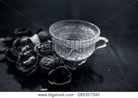 Close Up Of Herbal Organic Tea Of Wall Nut Or Walnut Tea In A Transparent Glass Cup With Raw Wall Nu