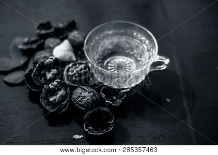 Close Up Of Herbal Organic Tea Of Wall Nut Or Walnut Tea In A Transparent Glass Cup With Raw Wall Nu