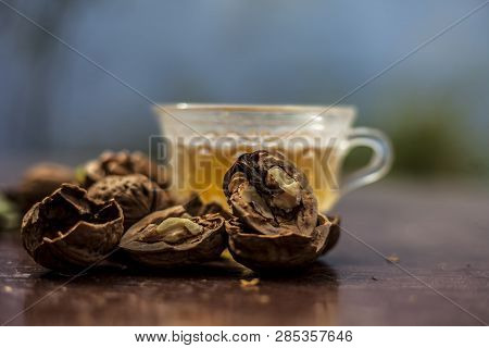 Close Up Of Herbal Organic Tea Of Wall Nut Or Walnut Tea In A Transparent Glass Cup With Raw Wall Nu