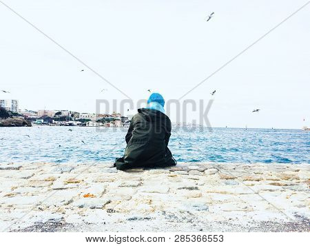 The Man Sitting At The Beautiful Blue Bay Of Mediterranean Sea In City Of Marselle While Some Seagal