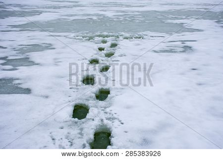 Photo Of Winter Scene Fall Through Ice, Drowning Or Dangers Of Walking On Thin Ice Of Rivers, Lakes,