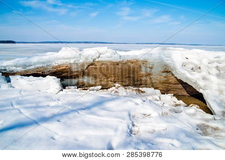 Blocks Of Ice Melt In The Spring On The Shore Of The Pond