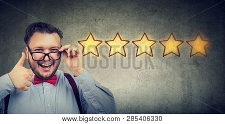 Сheerful Handsome Man Smiling Showing Thumb Up Like Gesture Choosing Five Stars Rating. Excellent Cu