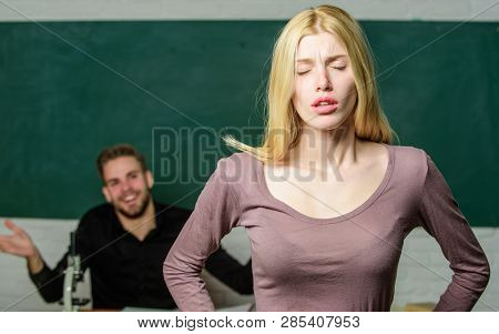 Stumbling Through A Lesson. Cute Woman Standing In Classroom With Teacher. University Or College Stu