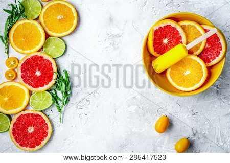 Citrus Slices With Fruit Popsicles On Table Background Top View Mock Up