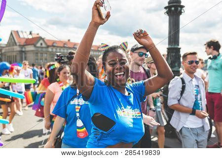 Prague, Czech Republic - August 11, 2018: African American Young Woman Dancing And Smiling On The An