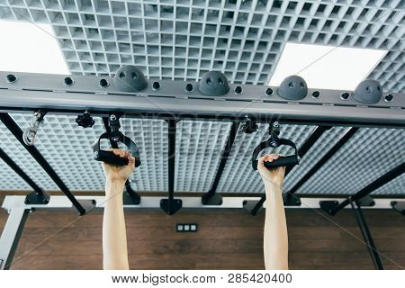 Closeup Detail Of Female Hands Holding A Pull-ups Bar In A Gym