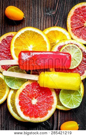 Citrus Popsicles With Fruit Slices On Wooden Background Top View