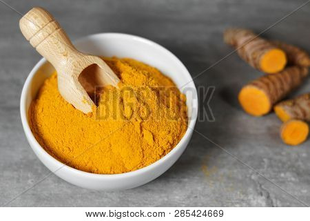 Turmeric Powder And Sliced Turmeric Roots Healthy Spice Asian Food Closeup Of A White Bowl With A Wo