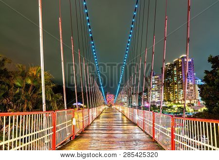 Bitan Suspension Bridge Across The Xindian River At Night. New Taipei City, Taiwan