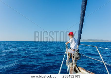 Little Boy On Board Of Sailing Yacht On Summer Cruise. Travel Adventure, Yachting With Child On Fami