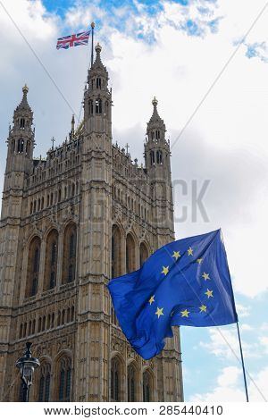E.u. Flag Flying In Front Of Union Ack Flag At Houses Of Parliament London