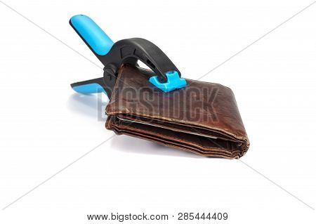 Old Worn Leather Wallet Held By An Industrial Clamp Over A White Background In A Conceptual Image Of