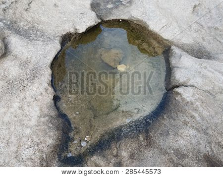 Water In Tidepool In Grey Rocks Or Stones