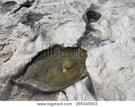 Water In Tidepool In Grey Rocks Or Stones
