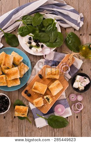 Spinach Puffs With Feta Cheese On Cuttingboard.