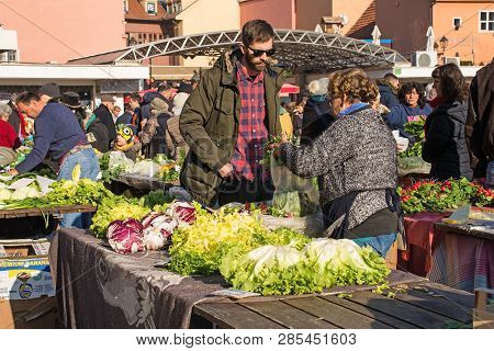 Zagreb, Croatia - December 29th 2018. A Stall Holder Serves A Customer At The Dolac Fresh Fruit And 