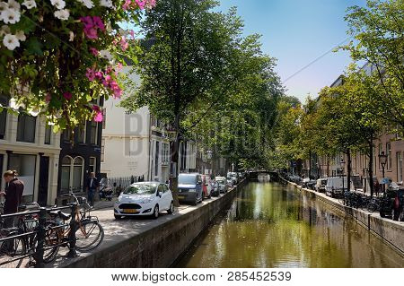 Amsterdam, Netherlands - September 17, 2018: Quiet Street, Canal, Bridge With Bicycles. Traditional 