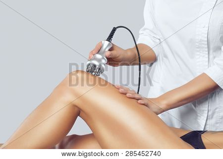 The Doctor Does The Rf Lifting Procedure On The Legs, Buttocks And Hips Of A Woman In A Beauty Parlo
