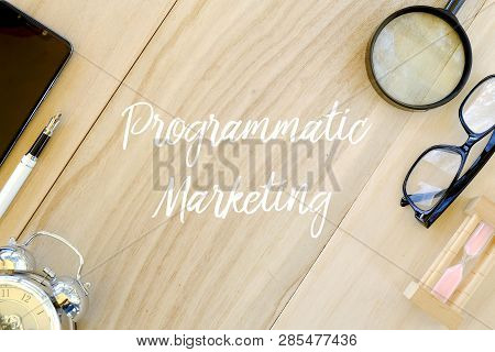 Top View Of Clock,pen,mobile Phone,magnifying Glass,glasses And Sand Clock On Wooden Background Writ