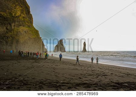 Vik, Iceland - May 09 2018: Tourists Admiring The Large Waves Th