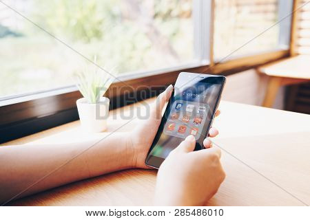 Chiang Mai, Thailand - Jan. 19,2019: Woman Holding Huawei With Icons Of E-commerce And Online Shoppi