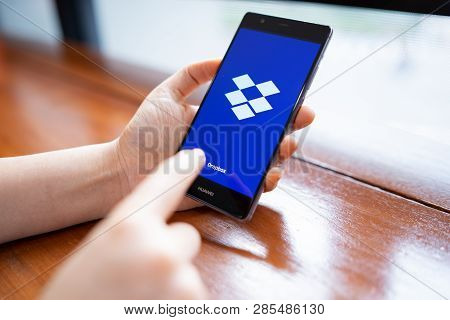 Chiang Mai, Thailand - Feb. 18,2019: Woman Holding Huawei With Dropbox On Screen. Dropbox Is A Servi