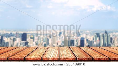 Empty Wooden Board Top Table In Front Of City Blurred Background. Perspective Wood In Blurred City S